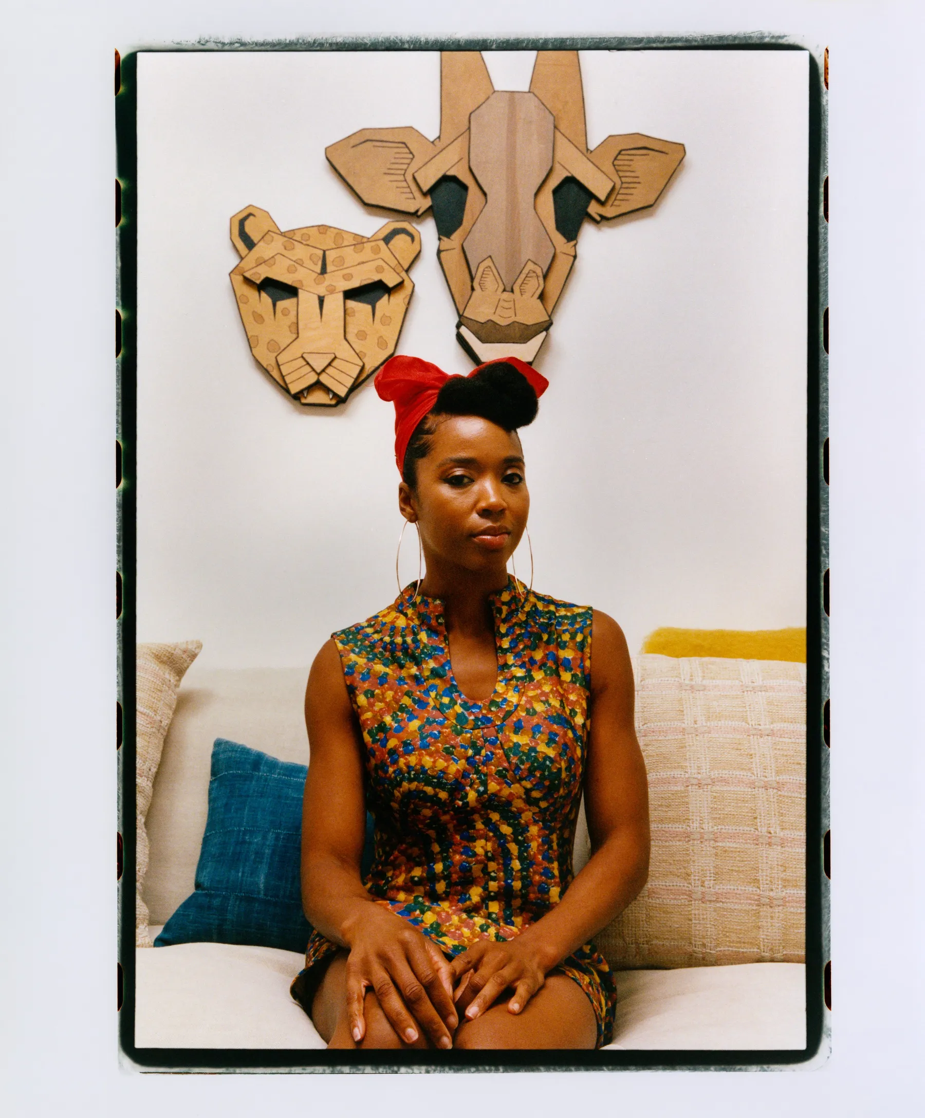 person sitting on couch in front of wooden art 