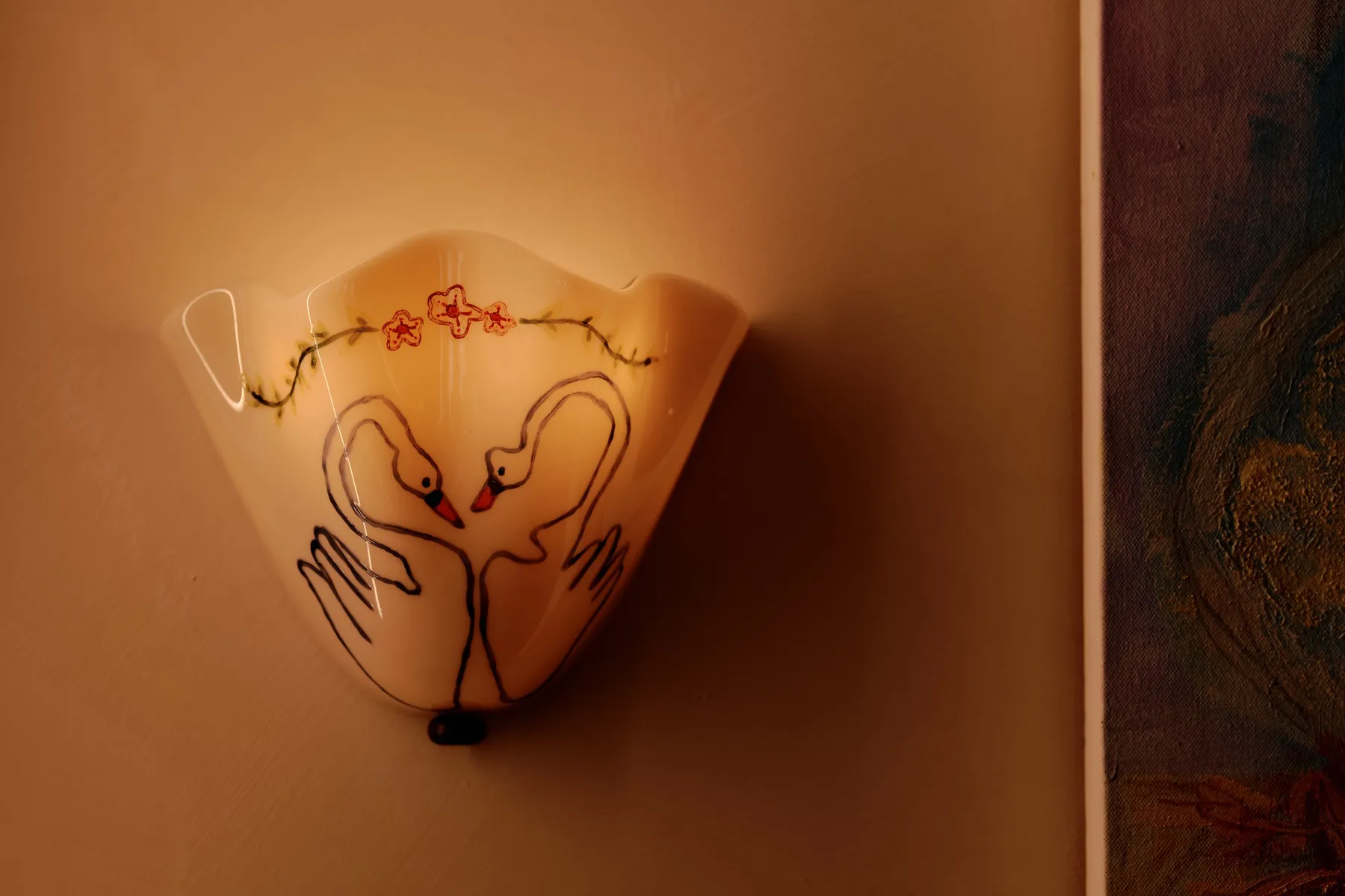 Decorated light fixture with swans 